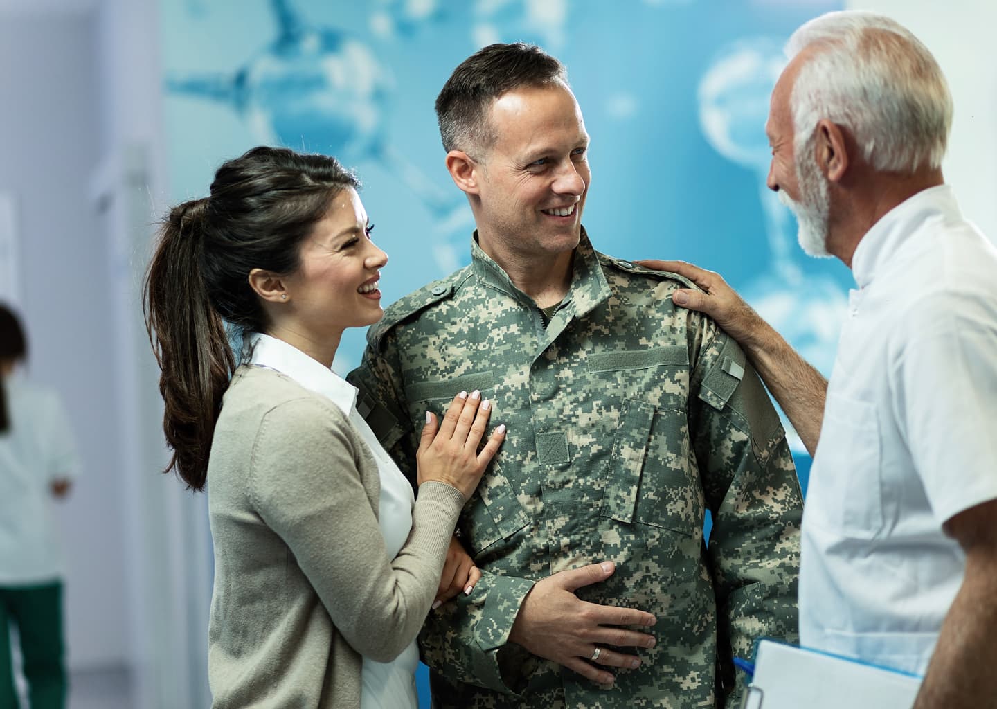 Military officer with his wife talking to the doctor