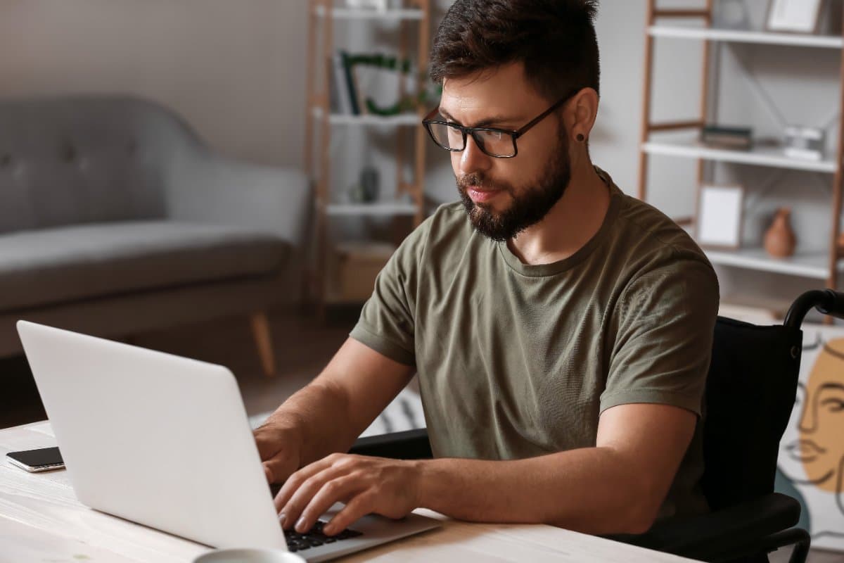 A U.S. military veteran reviews benefit information on a laptop at home.