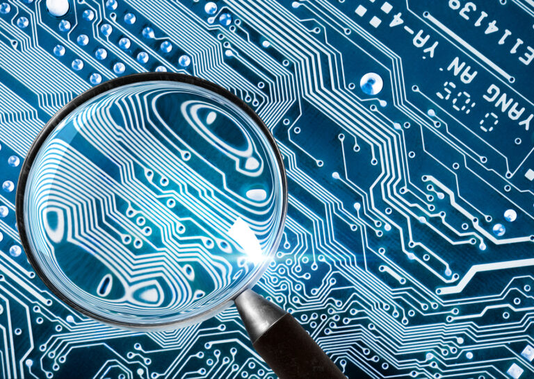 A magnifying glass hovering over a computer circuit board, sharp focus