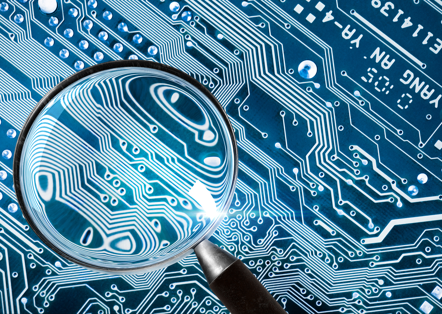 A magnifying glass hovering over a computer circuit board, sharp focus